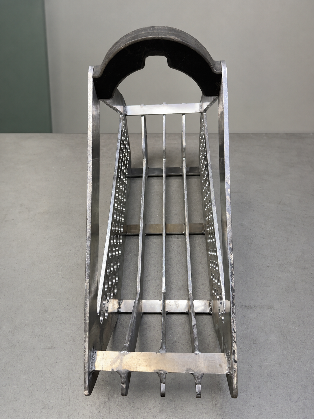 End view showing the structure and weld work of a fabricated steel piece.