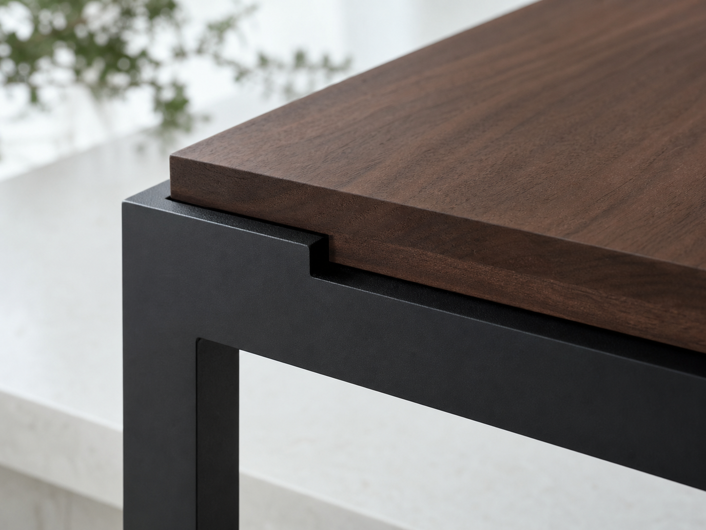 A clean walnut and matte black steel connection detail.